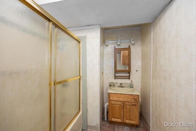 5359 Huck Dr, Sheridan, MI 48884 - bathroom with vanity, tile walls, and bath / shower combo with glass door