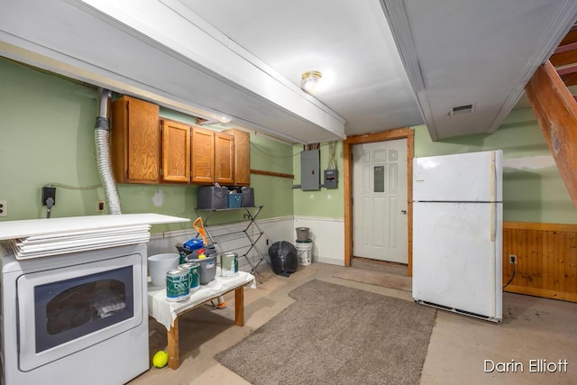 5359 Huck Dr, Sheridan, MI 48884 - kitchen featuring freestanding refrigerator, electric panel, concrete floors, a wainscoted wall, and washer / clothes dryer