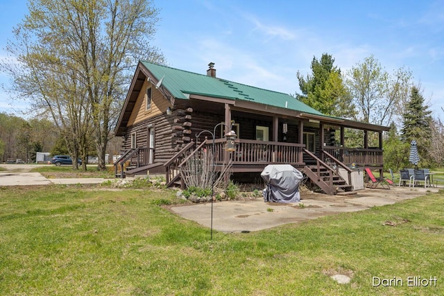 5359 Huck Dr, Sheridan, MI 48884 - log-style house with a front yard, log siding, stairs, a chimney, and metal roof