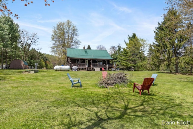 5359 Huck Dr, Sheridan, MI 48884 - view of grassy yard featuring a shed, an outdoor structure, and a deck