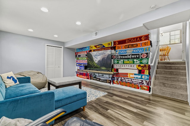 living room with wood finished floors, recessed lighting, and stairway