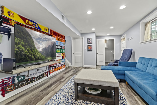 living area with recessed lighting, wood finished floors, and baseboards