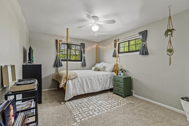 bedroom featuring baseboards, light carpet, and a ceiling fan