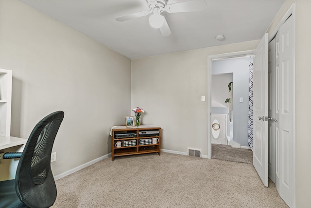 carpeted office featuring ceiling fan and baseboards
