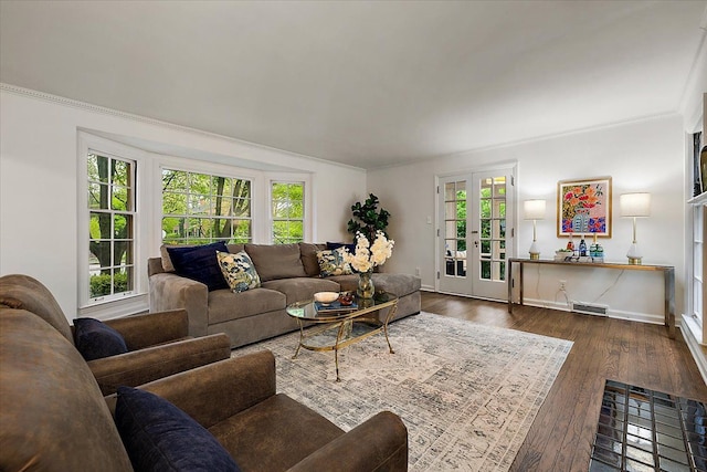 living room with healthy amount of natural light, ornamental molding, dark wood-type flooring, baseboards, and french doors