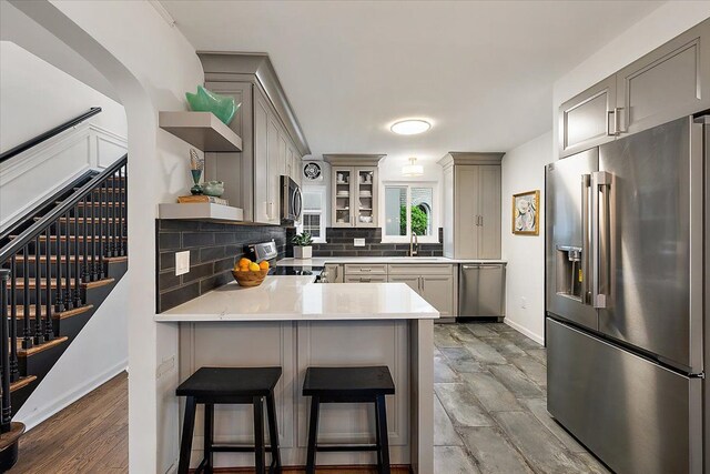75 Grosse Pointe Blvd, Grosse Pointe Farms, MI 48236 - kitchen with appliances with stainless steel finishes, gray cabinetry, and open shelves