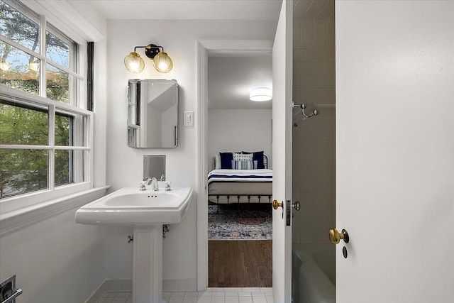 full bathroom with shower / washtub combination, baseboards, ensuite bathroom, and tile patterned flooring
