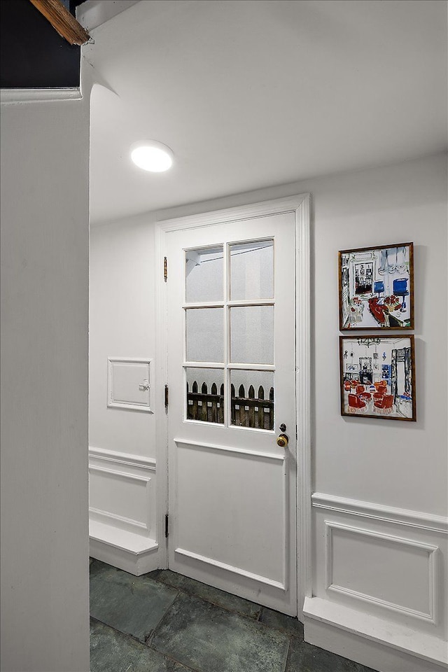 entryway with dark stone finish floors