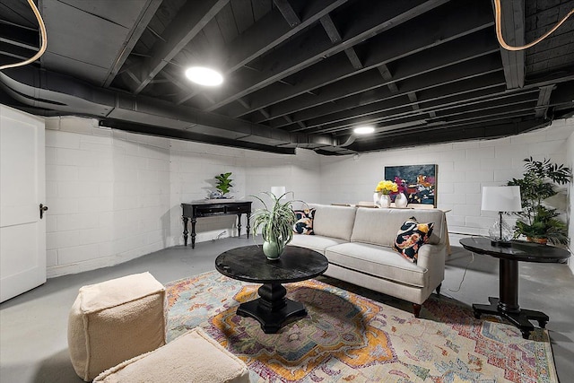 living room with concrete flooring and concrete block wall