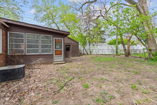 view of yard with central AC unit and fence