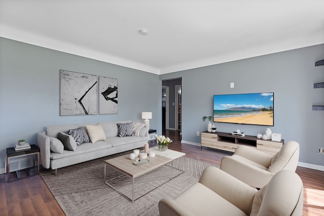 living area with wood finished floors and baseboards