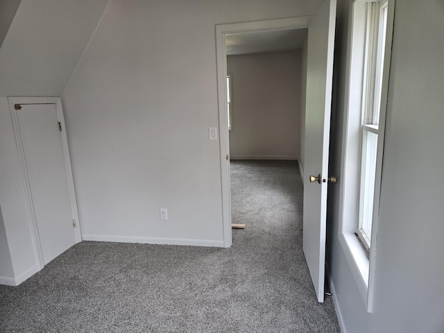 carpeted spare room featuring baseboards