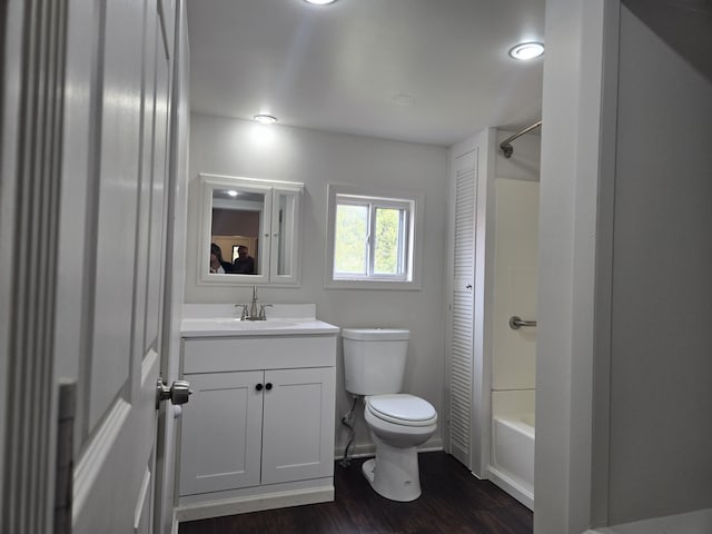 full bathroom featuring toilet, wood finished floors, vanity, and shower / bath combination