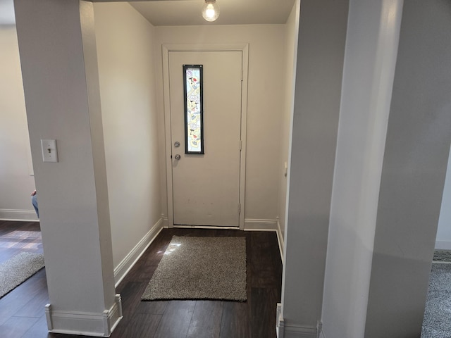 doorway to outside featuring dark wood finished floors and baseboards