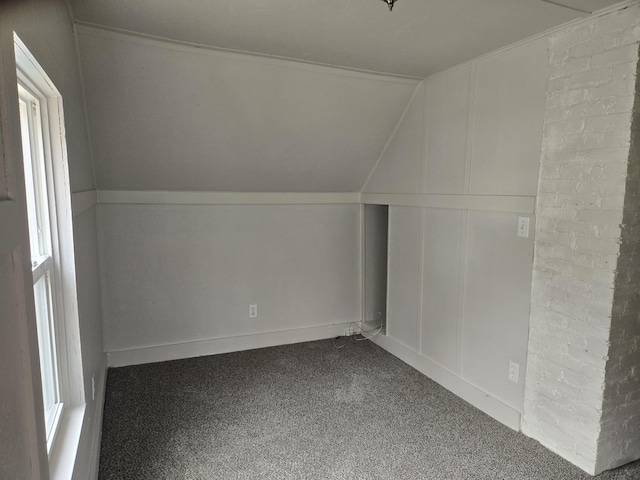 bonus room featuring carpet flooring and a decorative wall