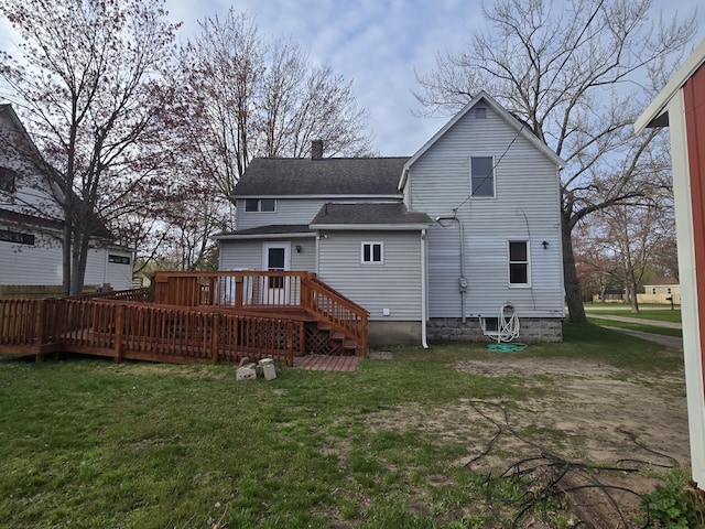 back of house with a shingled roof, a yard, a deck, and a chimney