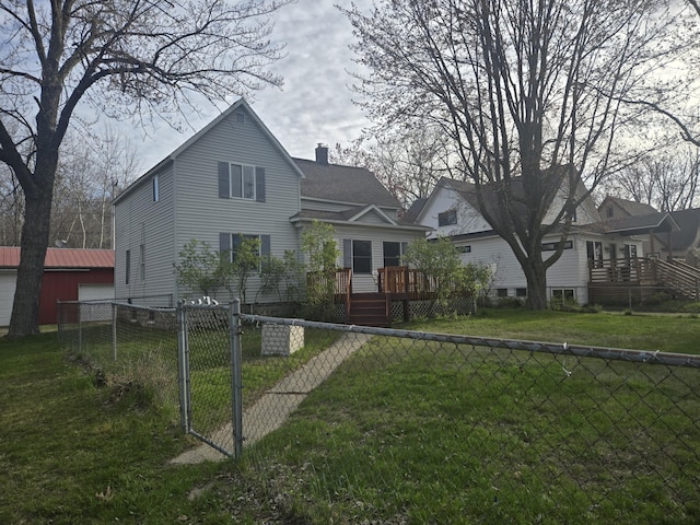 back of house featuring a wooden deck, a chimney, and a gate