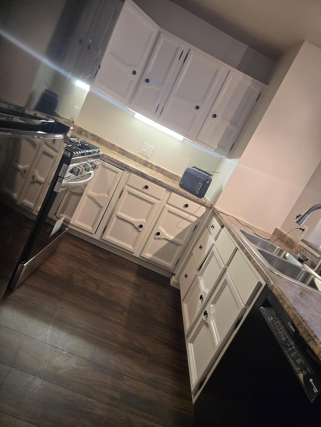 kitchen with a sink, white cabinetry, and dark wood-style floors