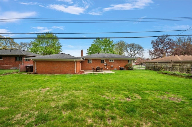 back of property featuring a patio area and brick siding