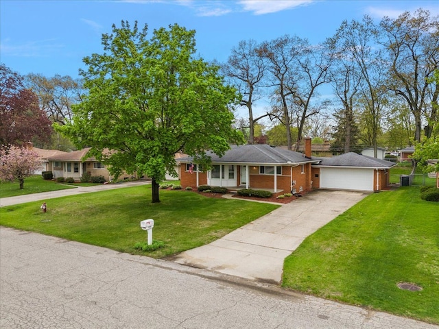 ranch-style home with an attached garage, driveway, a front yard, brick siding, and a chimney
