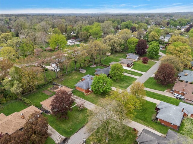 aerial overview of property's location with nearby suburban area and a heavily wooded area