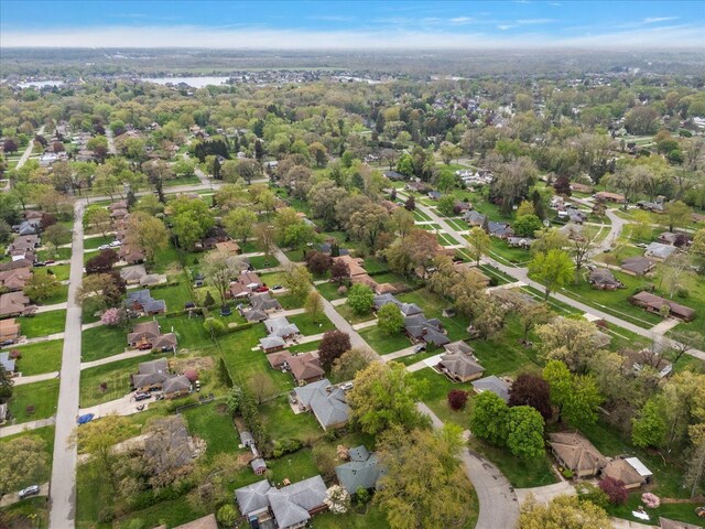 aerial view of property and surrounding area with nearby suburban area
