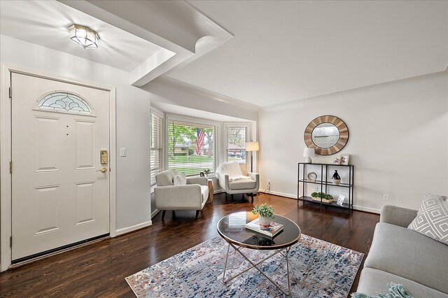 foyer with wood finished floors and baseboards
