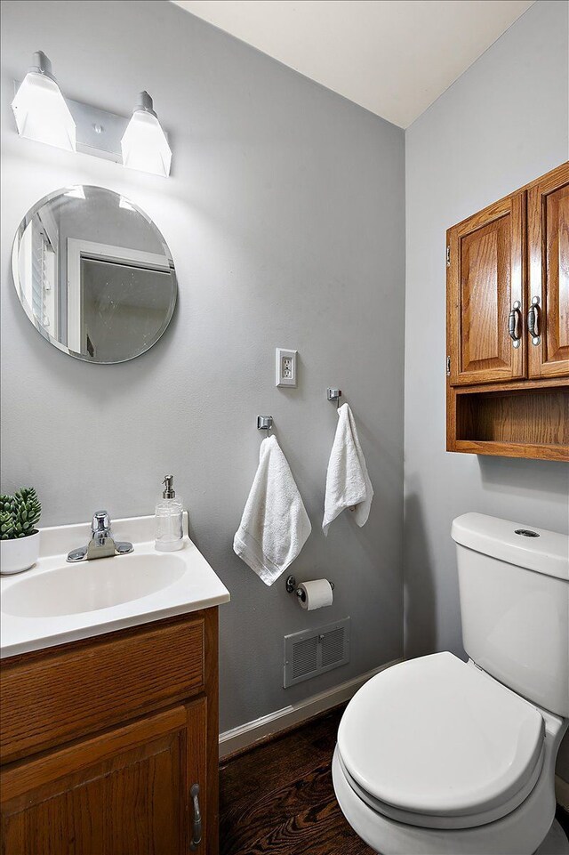 bathroom featuring toilet and vanity