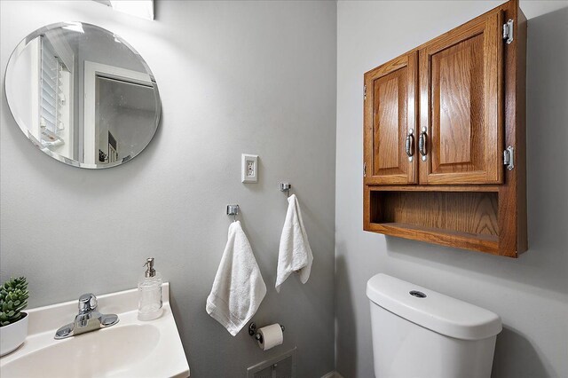 half bath featuring a sink and toilet