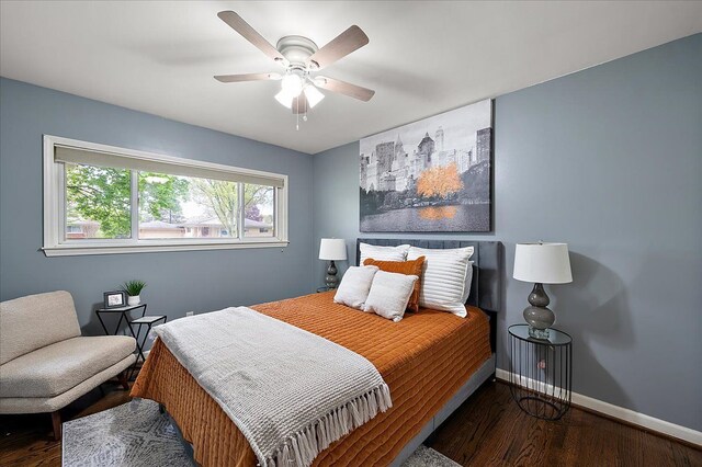 bedroom with wood finished floors, baseboards, and ceiling fan