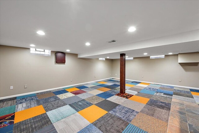 basement with baseboards and recessed lighting