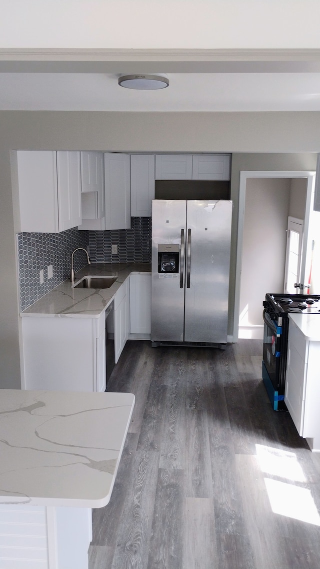 23162 Saxony Ave, Eastpointe, MI 48021 - kitchen with stainless steel refrigerator with ice dispenser, black electric range oven, a sink, dark wood-style flooring, and light stone countertops