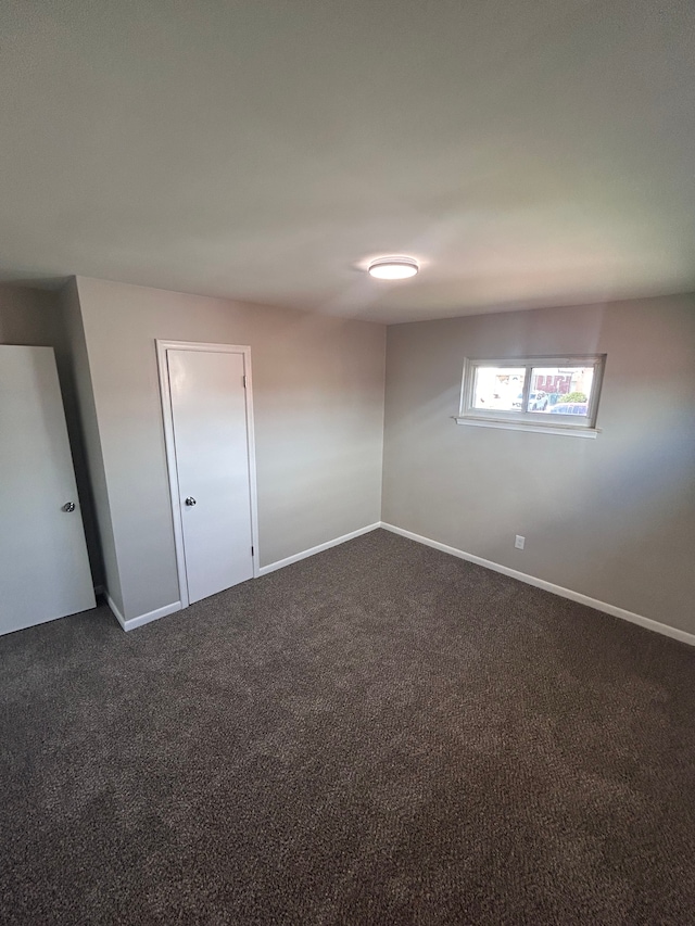 23162 Saxony Ave, Eastpointe, MI 48021 - empty room featuring dark colored carpet and baseboards