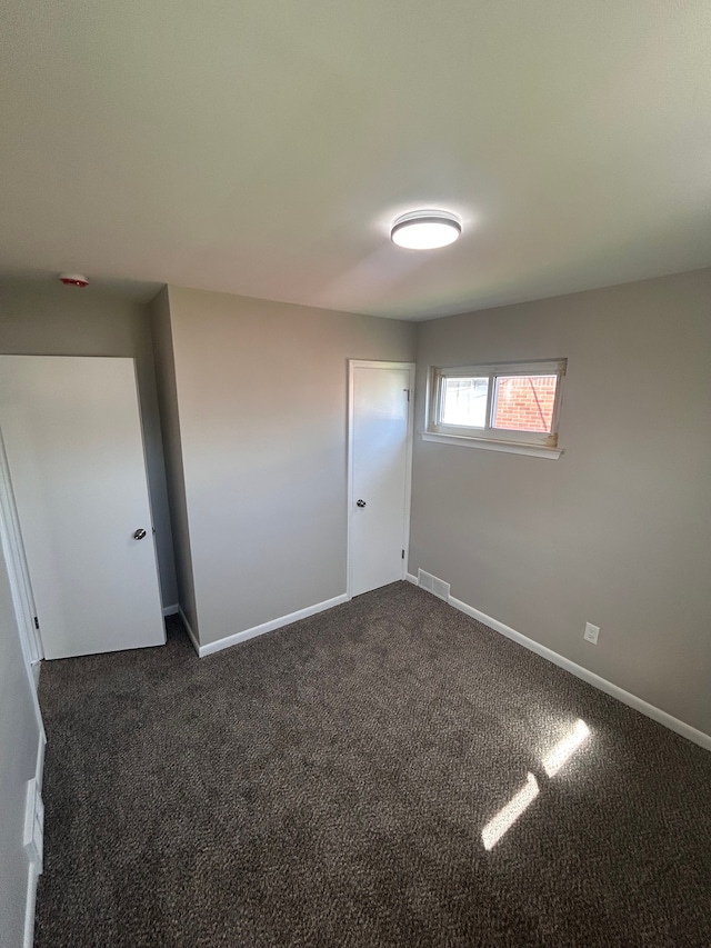 23162 Saxony Ave, Eastpointe, MI 48021 - spare room featuring dark colored carpet and baseboards