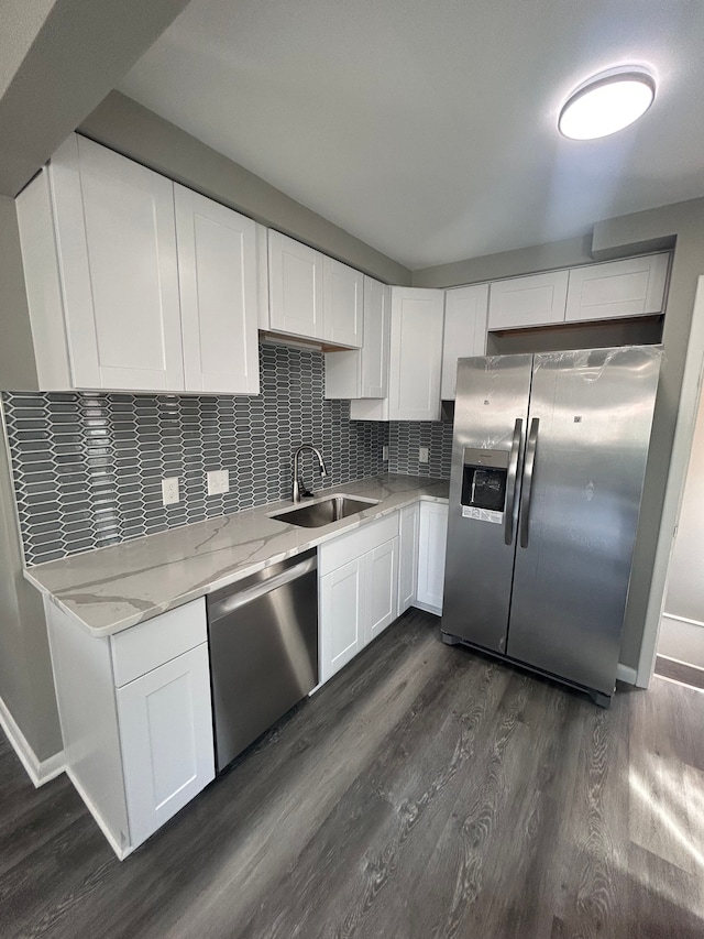 23162 Saxony Ave, Eastpointe, MI 48021 - kitchen with appliances with stainless steel finishes, a sink, dark wood-style flooring, white cabinets, and tasteful backsplash