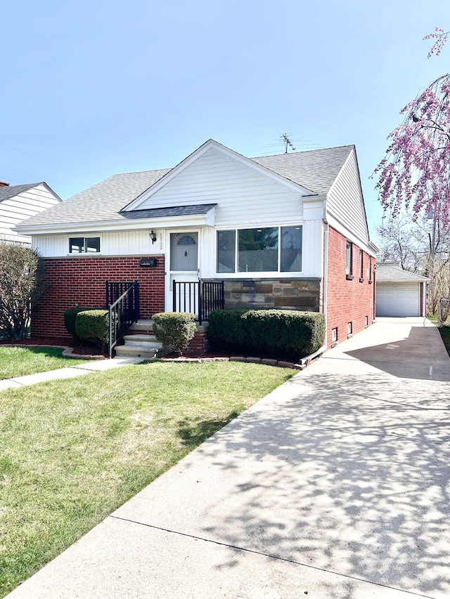 23162 Saxony Ave, Eastpointe, MI 48021 - view of front of property featuring brick siding, roof with shingles, an outdoor structure, and a front lawn