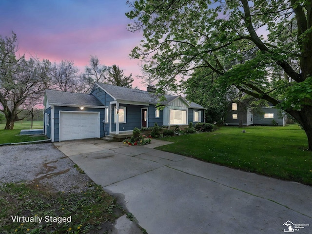 single story home featuring an attached garage, driveway, and a front lawn