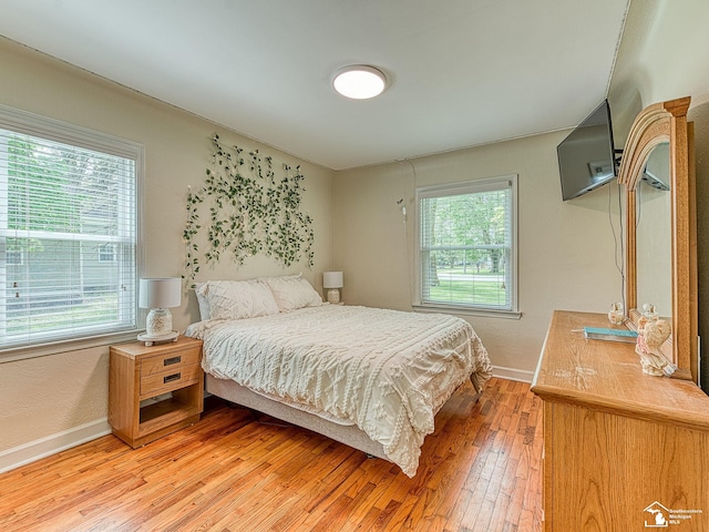 bedroom featuring baseboards and light wood-style floors