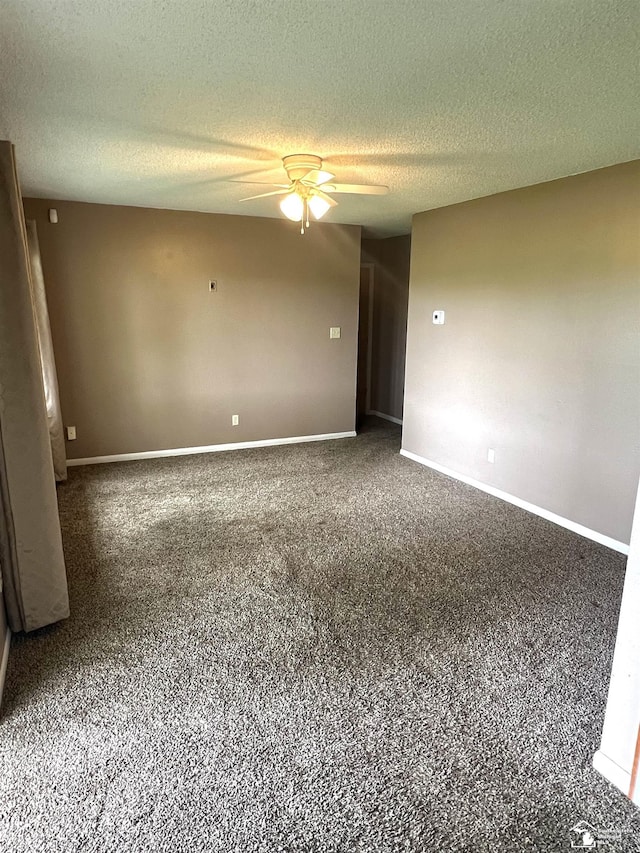 carpeted spare room with ceiling fan, a textured ceiling, and baseboards