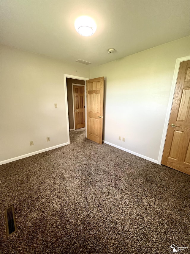 unfurnished bedroom featuring baseboards and carpet flooring