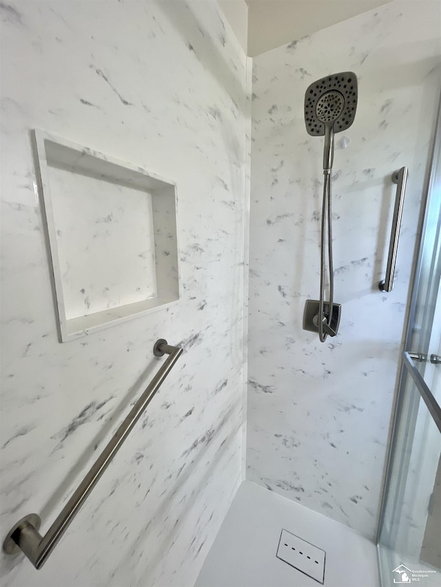 full bathroom featuring a marble finish shower