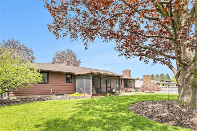 back of property with a sunroom and a chimney