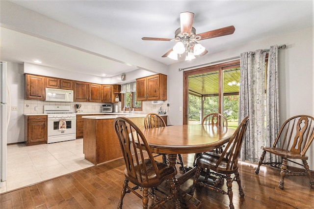 dining space with a ceiling fan, light wood-style floors, and recessed lighting