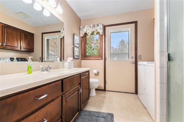 bathroom featuring separate washer and dryer, toilet, vanity, and tile patterned floors