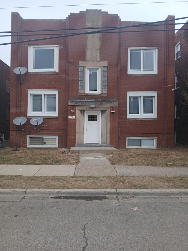 view of property with brick siding