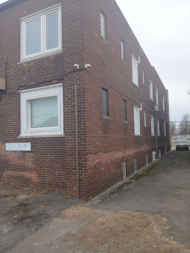 view of side of property featuring brick siding
