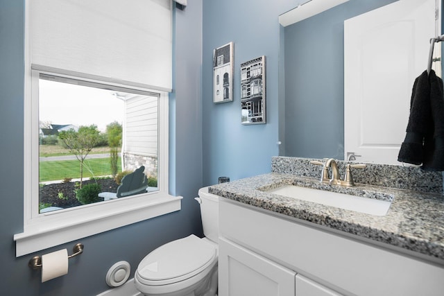 half bathroom featuring toilet and vanity