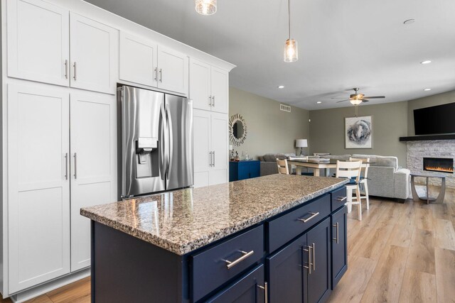 kitchen with stainless steel fridge with ice dispenser, blue cabinetry, a ceiling fan, white cabinetry, and recessed lighting