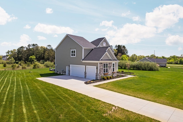 view of side of property with a garage, a yard, stone siding, and driveway
