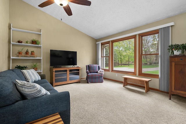 carpeted living area featuring vaulted ceiling, a textured ceiling, ceiling fan, and baseboards